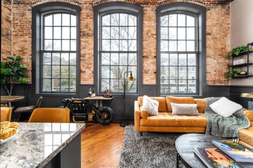 a living room with a couch and a table at 547 Cherry Loft 201 - The Rookery - Luxe Property in Macon