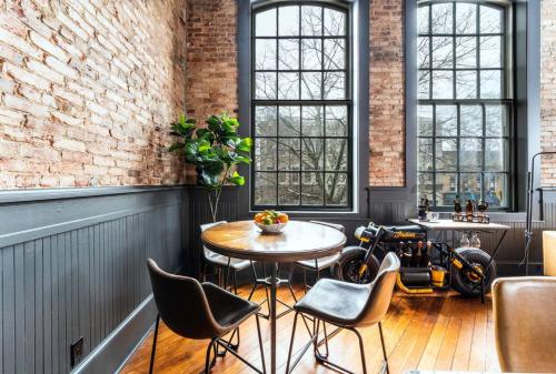 a room with a table and a motorcycle in it at 547 Cherry Loft 201 - The Rookery - Luxe Property in Macon