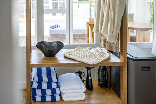 a shelf with towels on it next to a window at Endless Summer Pool Club at Mahogany Bay Unit C in San Pedro