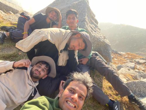 a group of men laying on the side of a mountain at North Katmor homestay in Haripūr