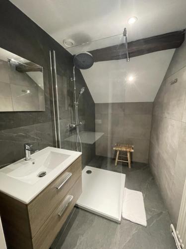 a bathroom with a white sink and a shower at 18 4p Authentic Cosy Cottage in Voerendaal
