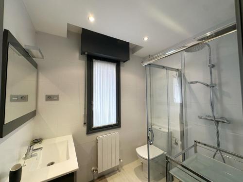 a bathroom with a shower and a sink and a toilet at Maralfrente de Noja- 6020 in Noja