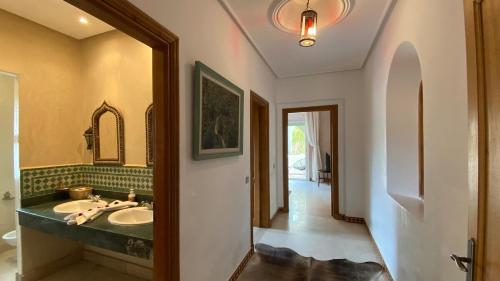 a bathroom with a sink and a mirror at Dar El Hana 4 Bedroom Villa in Marrakech