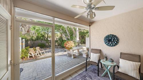 a living room with a sliding glass door and a patio at Sunset Sanctuary in Longboat Key