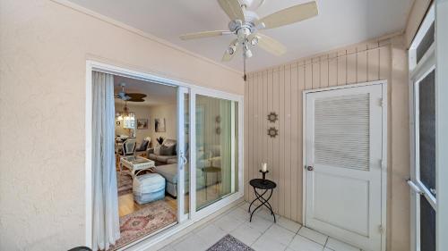 a room with a ceiling fan and a living room at Sunset Sanctuary in Longboat Key