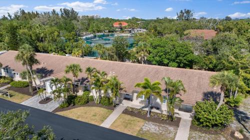 an aerial view of a house with a pool and palm trees at Sunset Sanctuary in Longboat Key