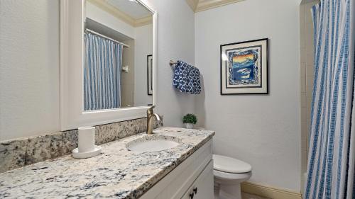 a bathroom with a sink and a toilet at Sunset Sanctuary in Longboat Key