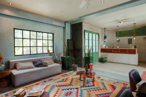 a living room with a couch and a table at Turquoise Tulum Hotel in Tulum
