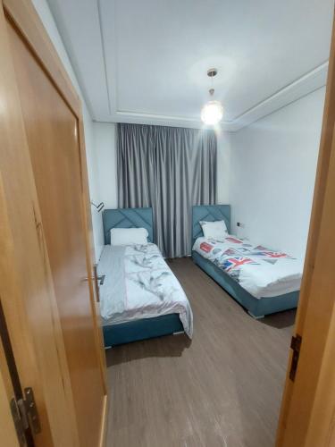Cama o camas de una habitación en Safari Stay Appart front mer avec piscine