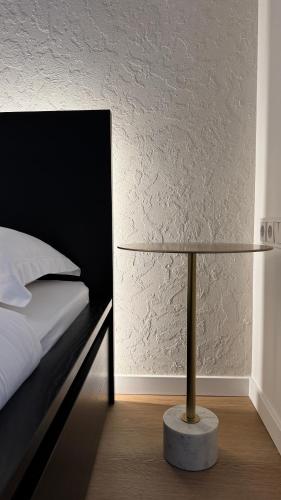 a bedroom with a bed and a table with a lamp at EVA boutique apartments in Vilnius