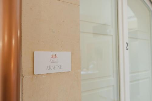 a sign on a wall next to a door at xenia apartments & suite in Siracusa