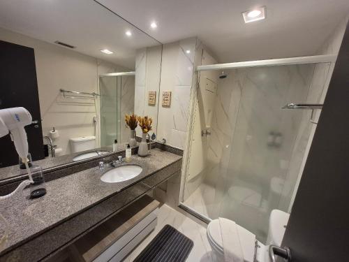 a bathroom with a shower and a sink and a toilet at Suíte Luxo Congonhas com sofá cama (Apto 2005H) in Sao Paulo