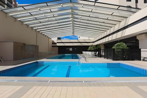 an indoor swimming pool with awning over a building at Suíte Luxo Congonhas com sofá cama (Apto 2005H) in Sao Paulo