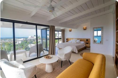 a hotel room with a bed and a large window at Urban Boutique Hotel in Las Terrenas