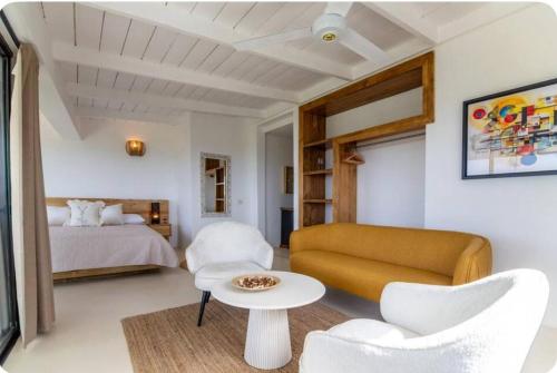 a living room with a couch and a bed at Urban Boutique Hotel in Las Terrenas