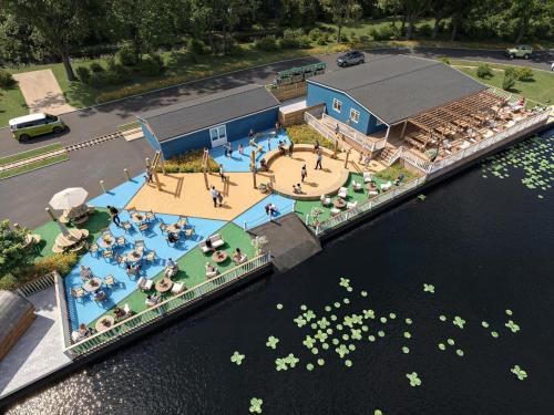 an overhead view of a swimming pool next to the water at Cosy cabin for 6 in Great Billing in Great Billing