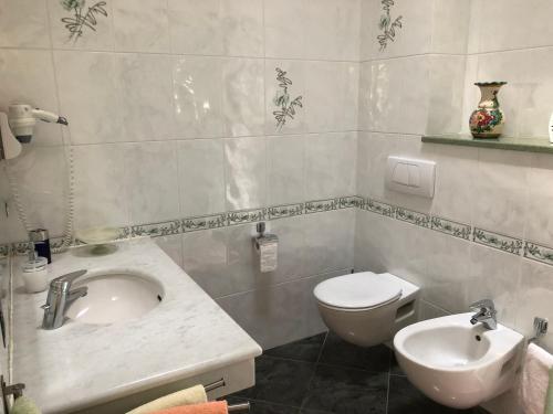 a bathroom with a sink and a toilet at Holiday Home Villa Bobolino in Montelupo Fiorentino