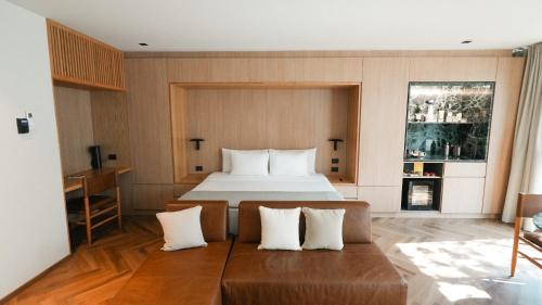 a bedroom with a bed and a couch in it at Rodona Hotel in Mexico City
