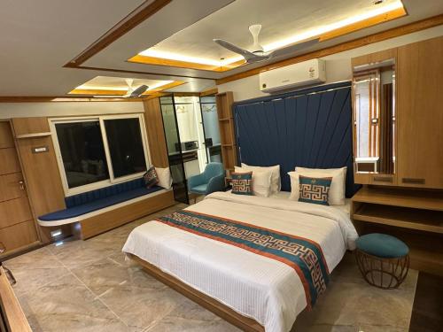 a bedroom with a large bed and a large window at The VP Residency Towerrs in Tiruttani