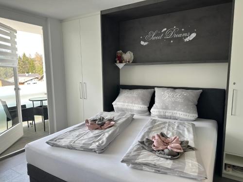 a bedroom with two beds with towels on them at Sweet Dreams Wellness Appartement in Seefeld in Tirol