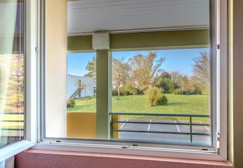 a window in a house with a view of a field at B&B HOTEL Brest Kergaradec Aéroport in Gouesnou
