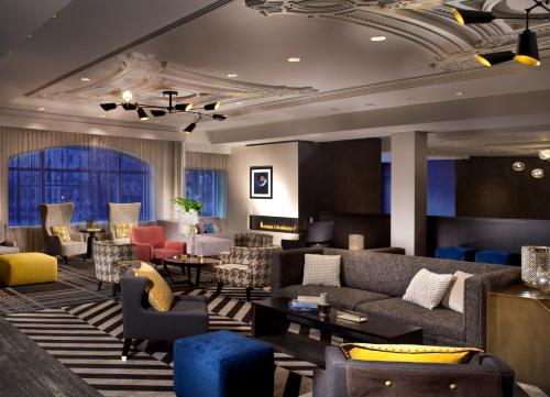 a hotel lobby with couches and chairs at Hotel Commonwealth in Boston