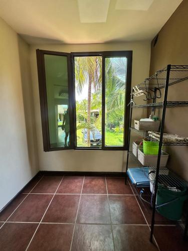 a room with a large window and a tiled floor at Pool and Jacuzzi Beachfront house CostaAzul ElSalvador in Acajutla