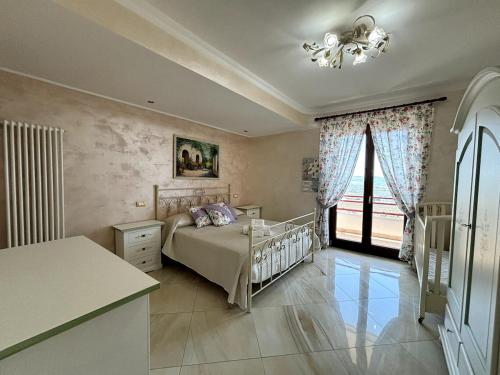a bedroom with a bed and a large window at Da Pupa, apartment with a sea view in Vico Equense