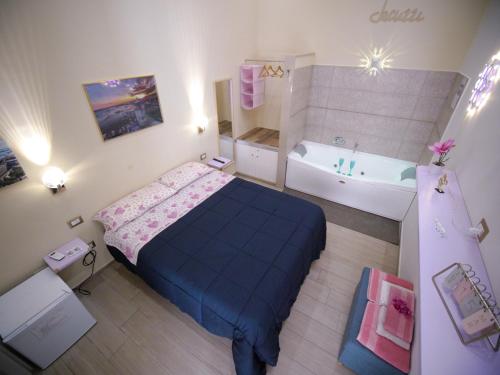 a small bedroom with a bed and a bath tub at ManfredoniaJacuzzi in Manfredonia