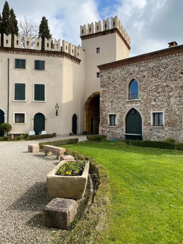 a large building with a grassy yard next to a building at Studio Ebi Vacation - Lazise in Colà di Lazise