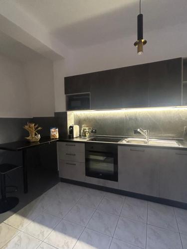 a kitchen with a sink and a stove at Vila Kurti in Vlorë