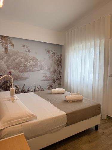 a bedroom with a bed with two towels on it at SUNSEA - Enjoy Your Family in Capo Vaticano