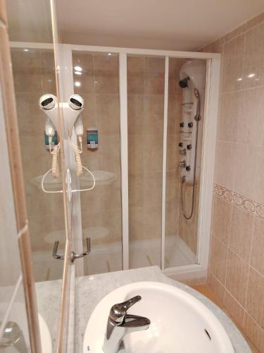 a bathroom with a shower and a white sink at Hotel Torre San Juan in San Juan de Alicante