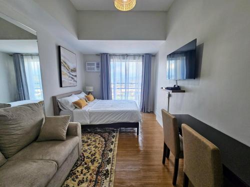 a living room with a bed and a couch at The Loop 2204 - Goff's Place in Cagayan de Oro