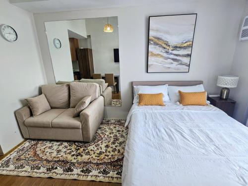 a bedroom with a bed and a couch and a chair at The Loop 2204 - Goff's Place in Cagayan de Oro