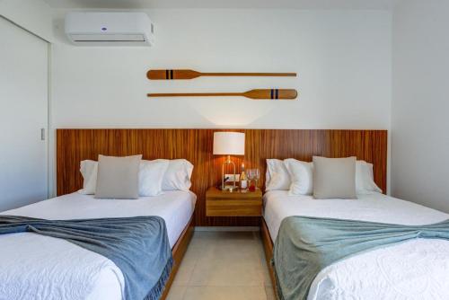 two beds sitting next to each other in a room at Aria Ocean Condominios in Nuevo Vallarta 