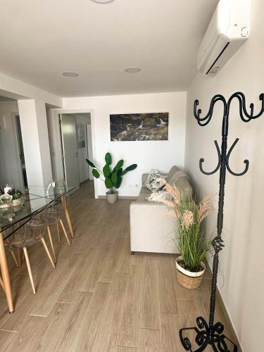 a living room with a table and a couch at Refúgio da Serra in Porto de Mós