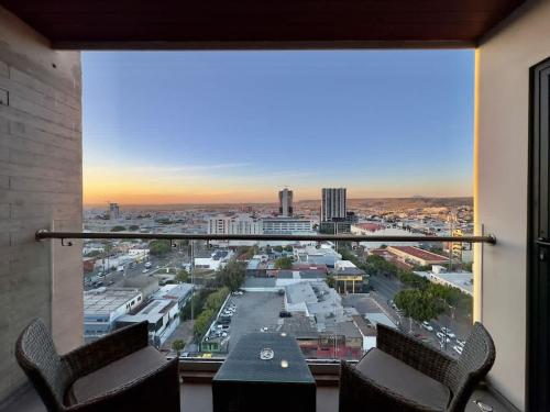 a large window with a view of a city at Downtown TJ Ave Revolucion 1BR Suite 10th floor in Tijuana