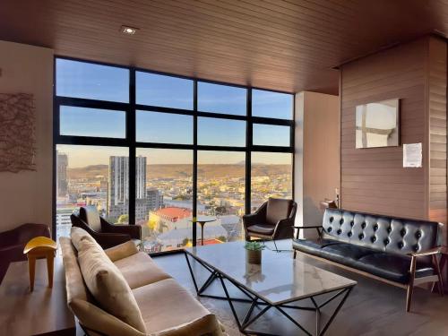 a living room with a couch and a table at Downtown TJ Ave Revolucion 1BR Suite 10th floor in Tijuana
