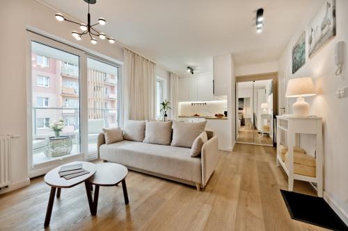 a living room with a couch and a table at Casa Baia BlueApart Hel in Hel