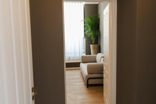 a living room with a couch and a chair and a window at xenia apartments & suite in Siracusa