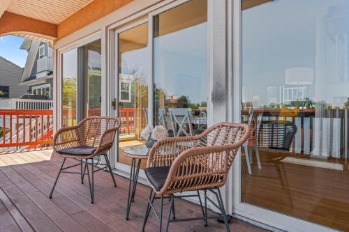 a porch with chairs and a table on a balcony at Waterfront Getaway - Dock UR Boat & Walk to Beach in Annapolis