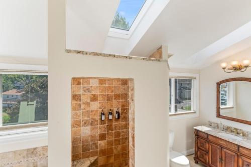 a bathroom with a shower and a sink and a mirror at Waterfront Getaway - Dock UR Boat & Walk to Beach in Annapolis