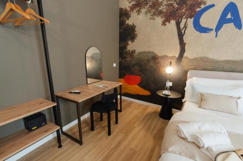 a room with a bed and a table and a mirror at xenia apartments & suite in Siracusa