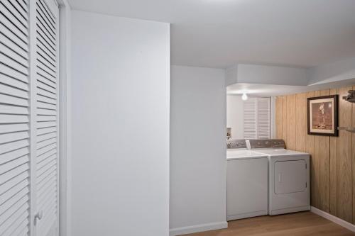 a white laundry room with a washer and dryer at Waterfront Getaway - Dock UR Boat & Walk to Beach in Annapolis