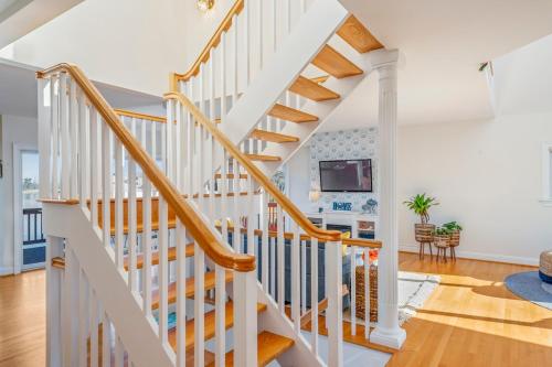 a white staircase with wooden railings in a home at Waterfront Getaway - Dock UR Boat & Walk to Beach in Annapolis