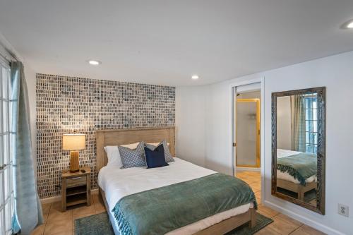 a bedroom with a bed and a mirror at Waterfront Getaway - Dock UR Boat & Walk to Beach in Annapolis