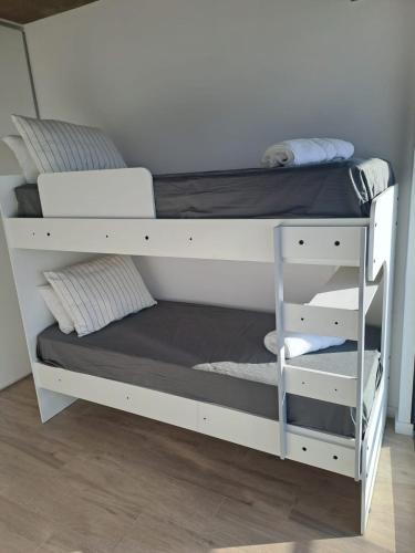 a bunk bed with a white bunk bed frame at Top Rentals Nuñez in Buenos Aires