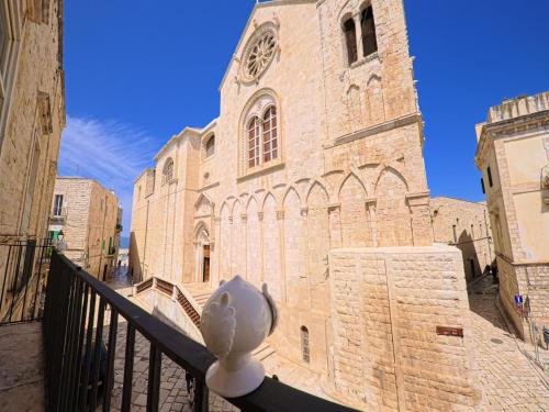 a large brick building with a clock tower at Palazzo Framarino dei Malatesta - Noble Floor - XIV Century in Giovinazzo