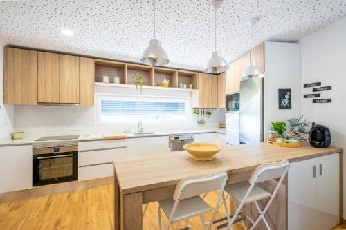 a kitchen with a wooden table and white cabinets at Gaeiras Private Pool in Gaieiras